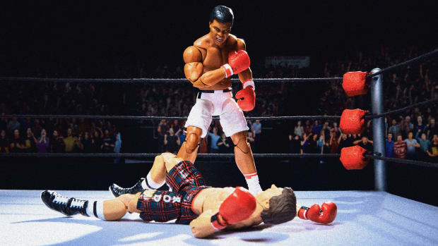 Muhammad Ali action figure standing over a defeated figure in a reenactment of the famous photo of him knocking out Sonny Liston